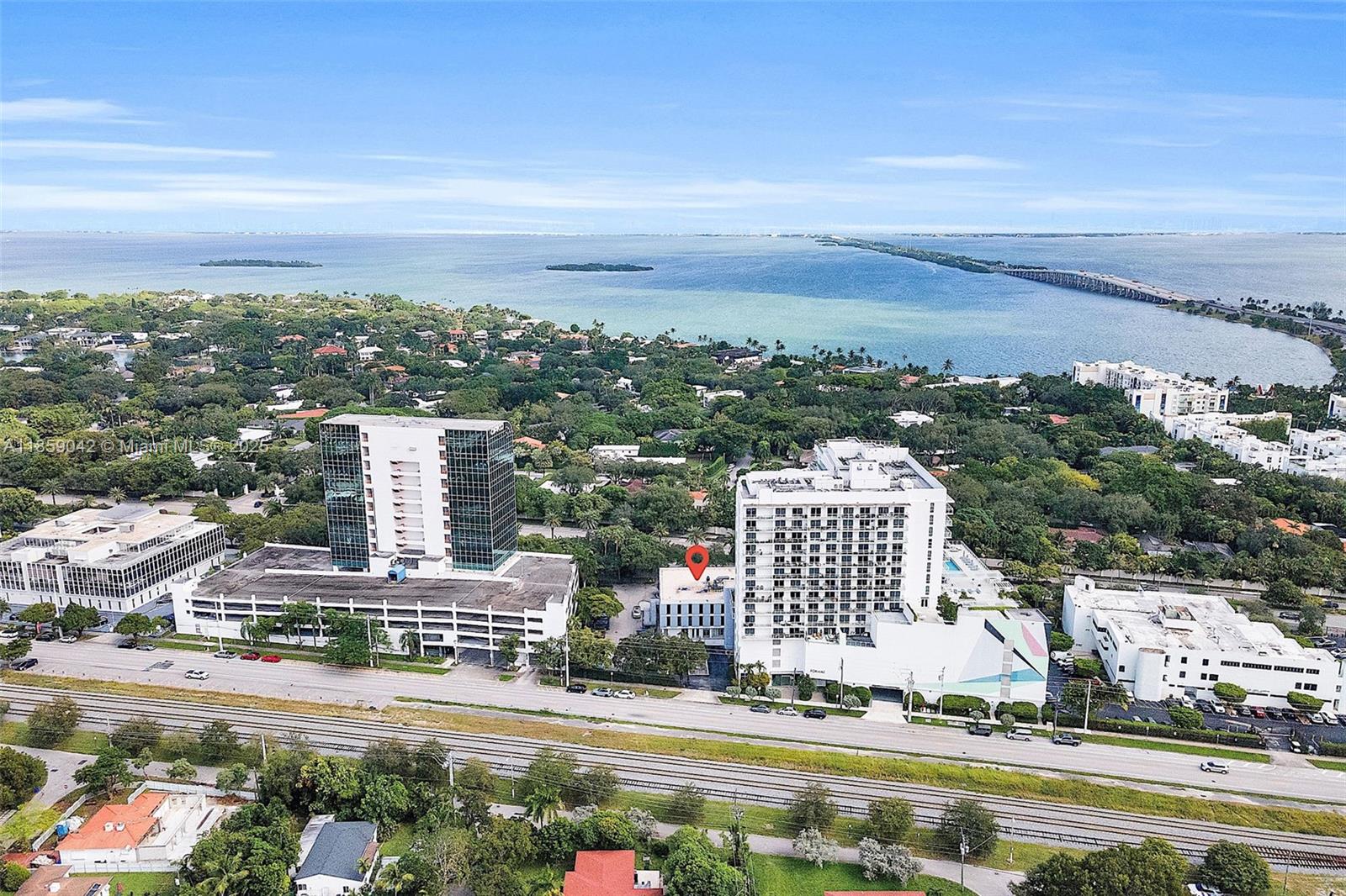 An aerial view shows a multi-story building marked with a red pin near a bay — 4300 Biscayne Blvd # G05, Miami FL 33137, MIAMI, FL