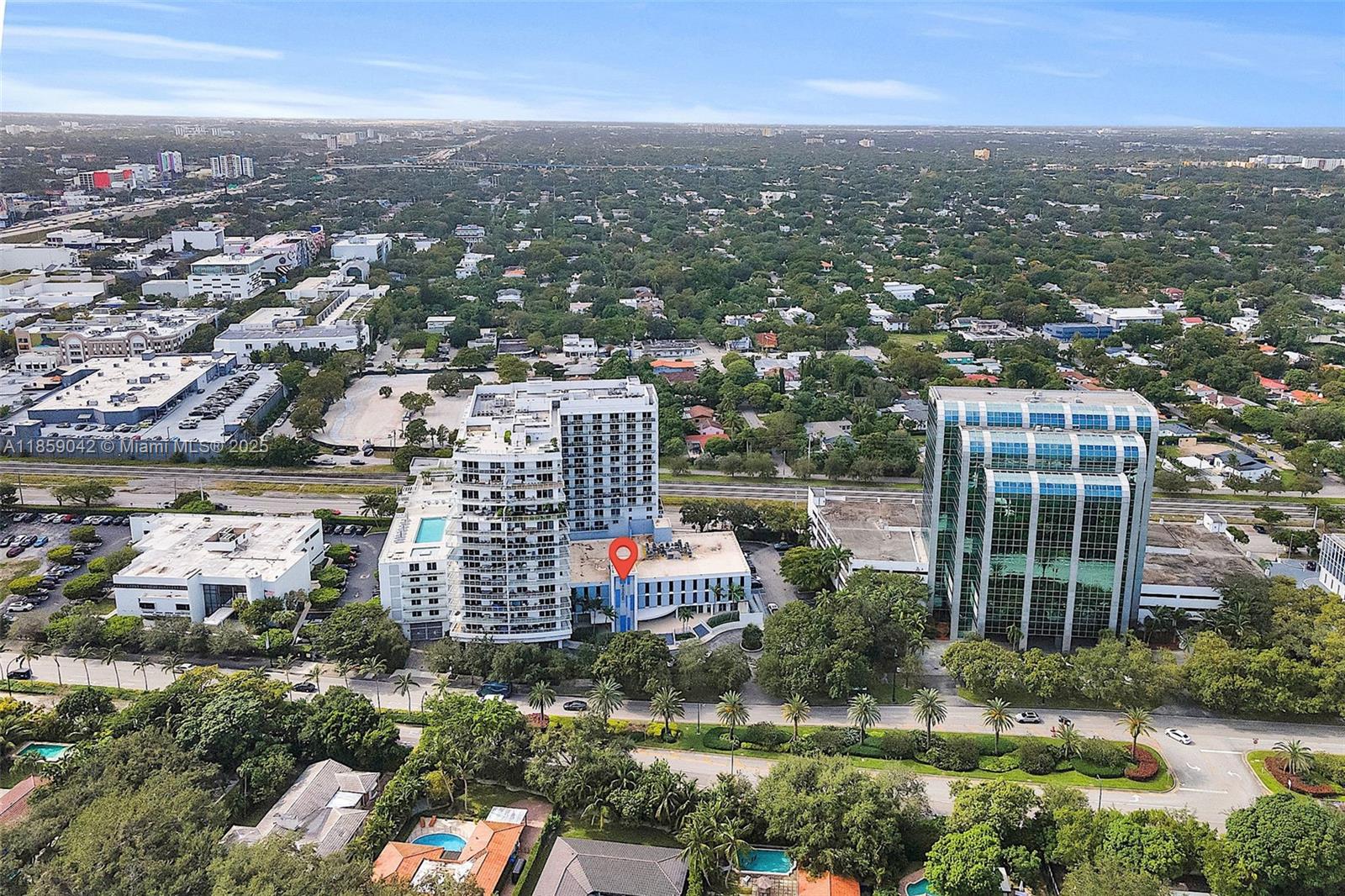 An aerial view shows a multi-story building with a red location pin and surrounding greenery — 4300 Biscayne Blvd # G05, Miami FL 33137, MIAMI, FL