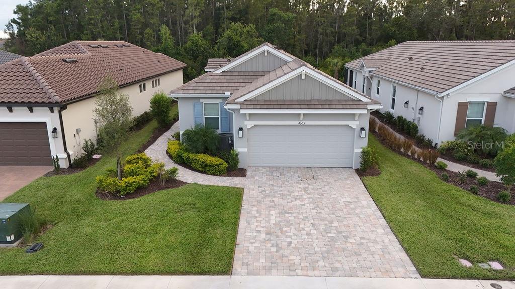 An aerial view of a single-story house with a paved driveway and a two-car garage — 4605 ROSATTI ROAD, WESLEY CHAPEL, FL