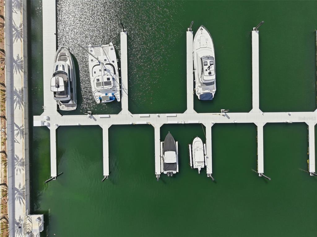 An aerial view shows five boats docked in individual slips at a marina — 5120 MARINA WAY UNIT 4408, TAMPA, FL