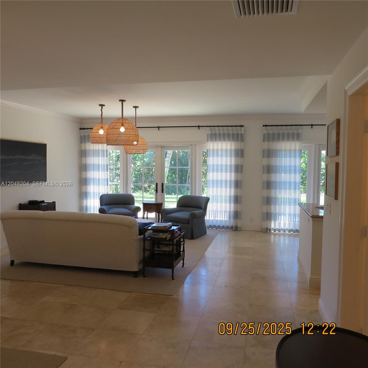 A living room features a white sofa, two blue armchairs, and striped curtains — 404 S Beach Rd # 404, Jupiter Island FL 33455, JUPITER ISLAND, FL