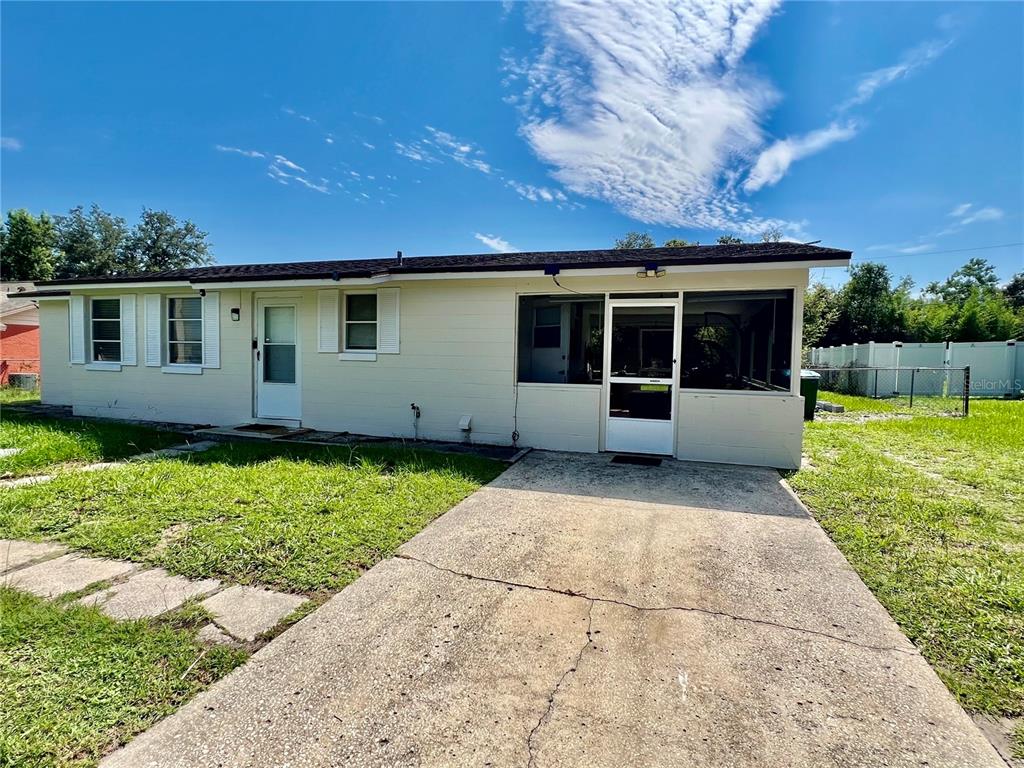 A single-story house with light-colored siding, a dark roof, and a front lawn — 1701 MONTECITO AVENUE, DELTONA, FL
