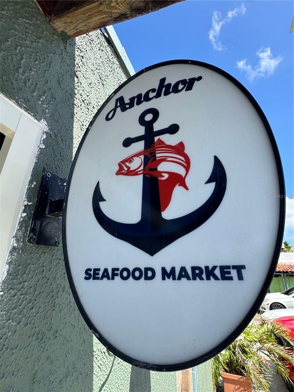 An oval sign for Anchor Seafood Market is mounted on a textured exterior wall — 2475 LOÍZA STREET, SAN JUAN, PR