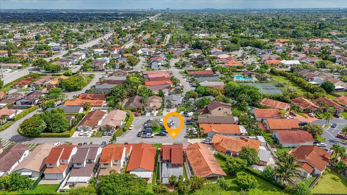 An aerial view shows a residential neighborhood with houses featuring red tile roofs — 10528 SW 69th Ter, Miami FL 33173, MIAMI, FL