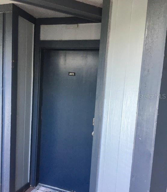 A dark blue front door with the number 3572 is set within a light-colored exterior wall — 3572 SOUTHPOINTE DRIVE UNIT 1, ORLANDO, FL