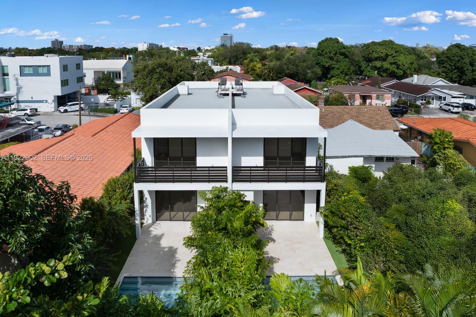 An aerial view of a modern two-story duplex with balconies, a patio, and a pool — 2610 SW 17th St, Miami FL 33145, MIAMI, FL
