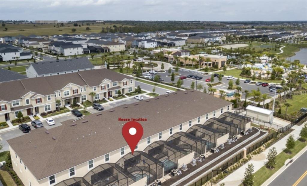 An aerial view shows a row of townhouses with screened-in back patios and pools — 1561 CAREY PALM CIRCLE, KISSIMMEE, FL