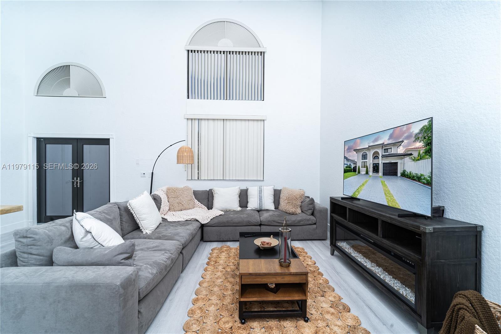 A living room features a gray sectional sofa, a coffee table, and a television console — 14172 NW 87th Ct, Miami Lakes FL 33018, MIAMI LAKES, FL