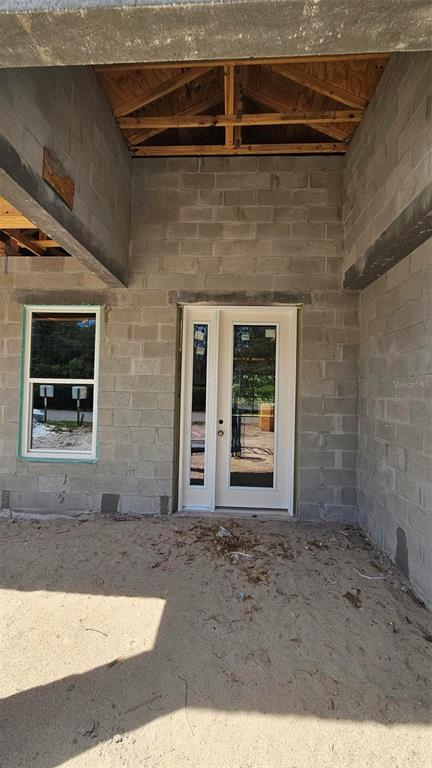 An unfinished kitchen features white upper cabinets and natural wood lower cabinets — 9149 TREVINO DRIVE, WEEKI WACHEE, FL