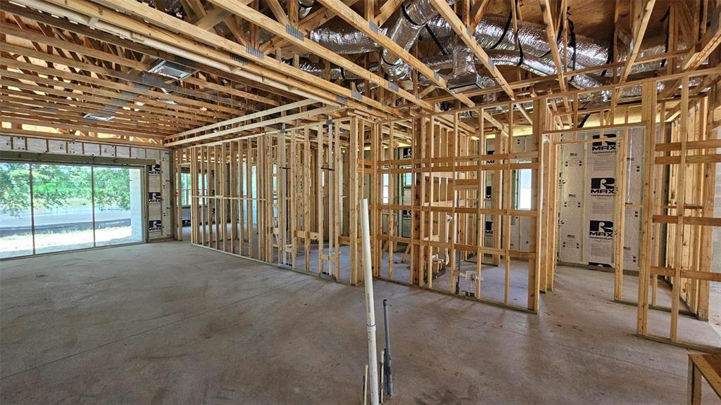 An unfinished kitchen features white upper cabinets, natural wood lower cabinets, and a central island — 9149 TREVINO DRIVE, WEEKI WACHEE, FL