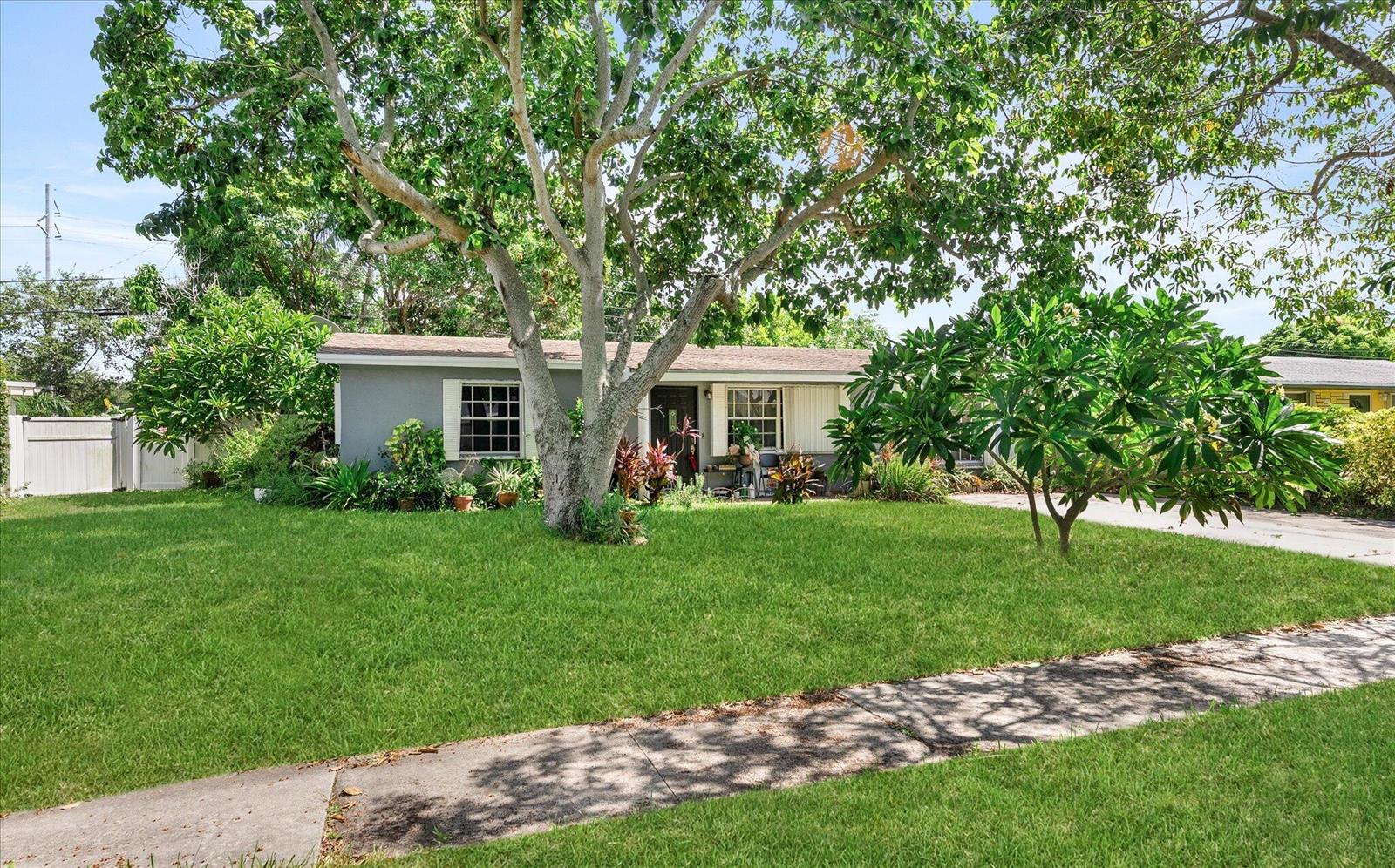 A single-story gray house with a large front yard and a prominent tree — 2106 WARE Drive, West Palm Beach FL 33409, WEST PALM BEACH, FL