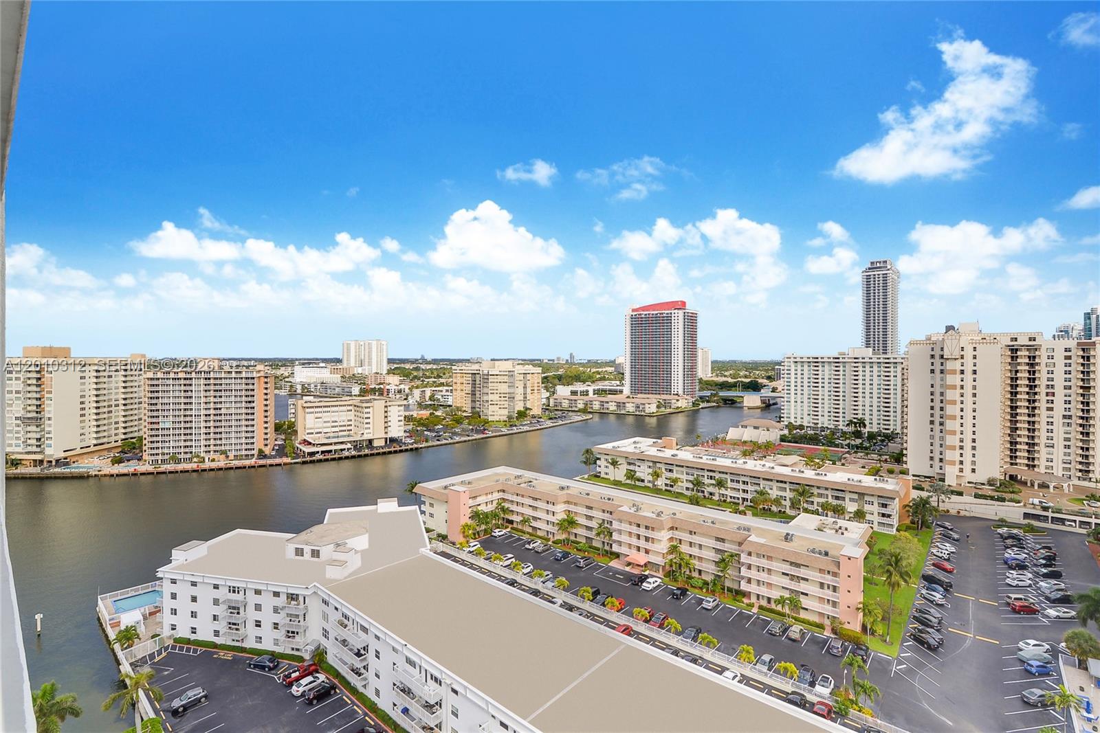 An elevated view of a waterway surrounded by high-rise apartment buildings and parking lots — 1945 S Ocean Dr # 1609, Hallandale Beach FL 33009, HALLANDALE BEACH, FL