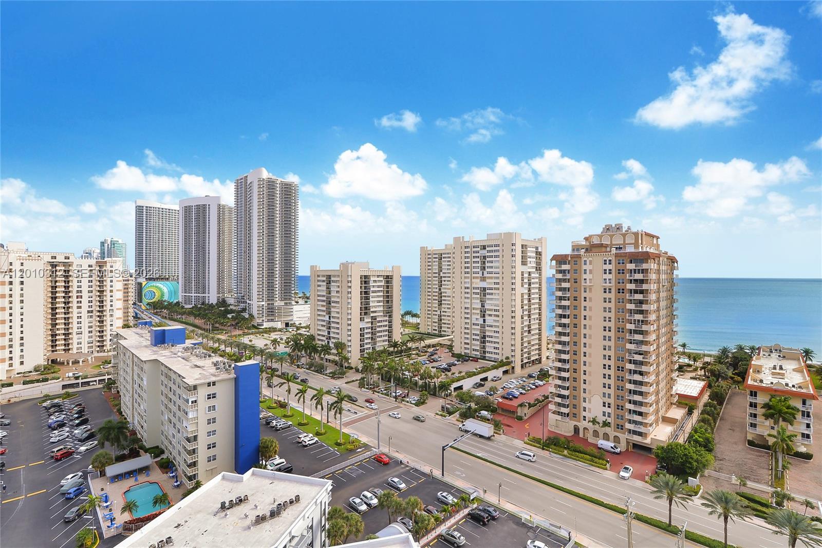 An elevated view shows multiple high-rise apartment buildings near a beach and a coastal road — 1945 S Ocean Dr # 1609, Hallandale Beach FL 33009, HALLANDALE BEACH, FL