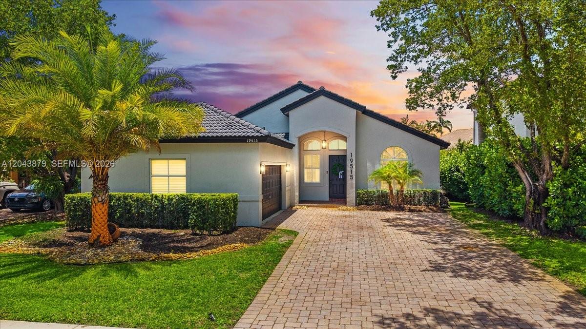A single-story house with a paved driveway, a palm tree, and a dark garage door — 19515 SW 25th Ct, Miramar FL 33029, MIRAMAR, FL