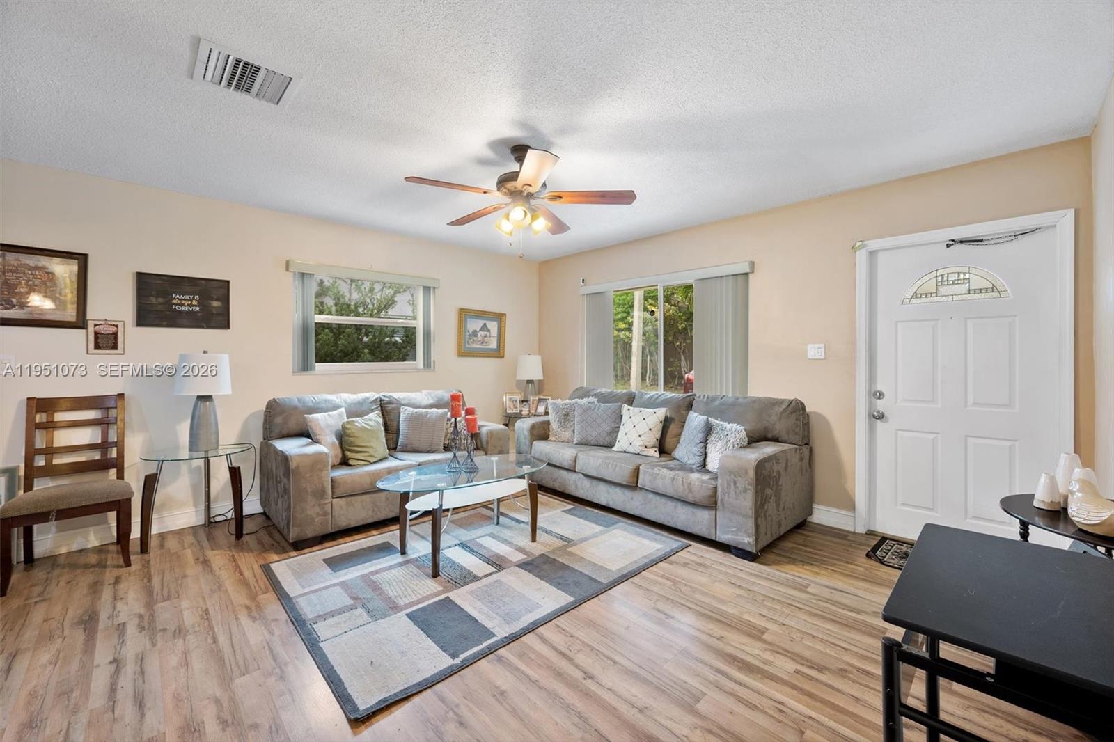 A kitchen features wood cabinets, granite countertops, stainless steel appliances, and an adjacent laundry area — 4714 NW 50th Ct, Tamarac FL 33319, TAMARAC, FL