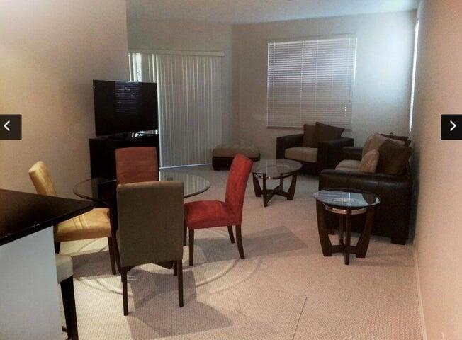 A living and dining area with a glass table, chairs, sofa, and carpeted flooring — 804 E Windward Way # 119, Lantana FL 33462, LANTANA, FL
