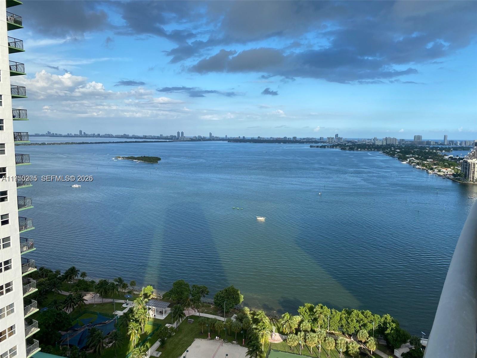 A high-angle view of a bay with a park in the foreground and city skyline — 1750 N Bayshore Dr # 3005, Miami FL 33132, MIAMI, FL