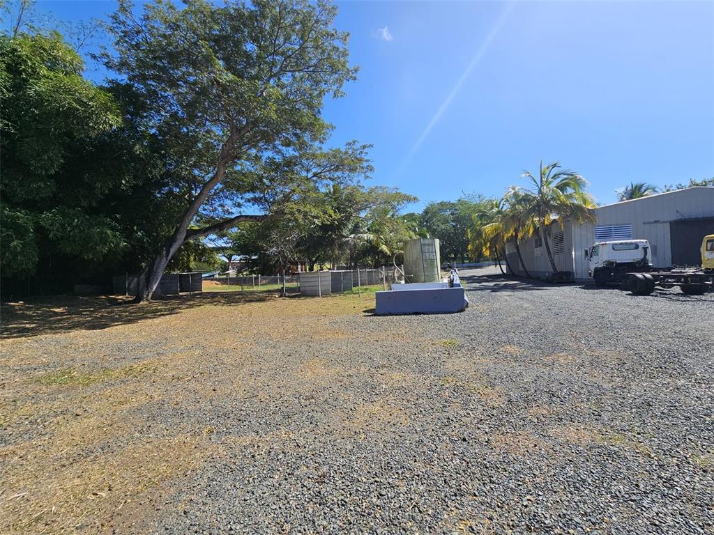 A gravel lot features a large tree, a water tank, and a warehouse with a truck — 101 CAMINO COFRESI, CABO ROJO, PR