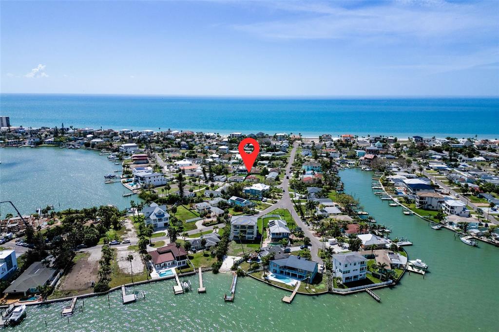 An aerial view shows a residential neighborhood with a red location pin on a house — 15822 REDINGTON DRIVE, REDINGTON BEACH, FL