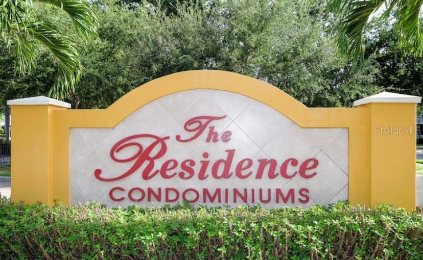 A yellow monument sign displays the text The Residence CONDOMINIUMS in front of green trees — 4149 RESIDENCE DRIVE UNIT 801, FORT MYERS, FL