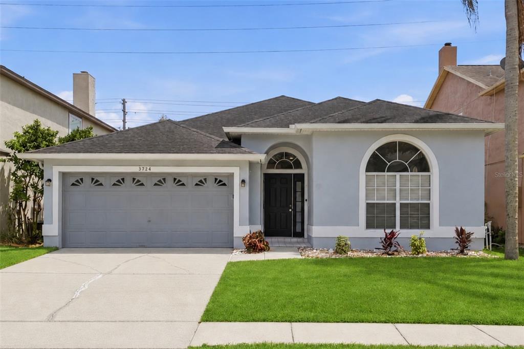 A single-story house with a gray exterior, a two-car garage, and a front lawn — 3724 BECONTREE PLACE, OVIEDO, FL