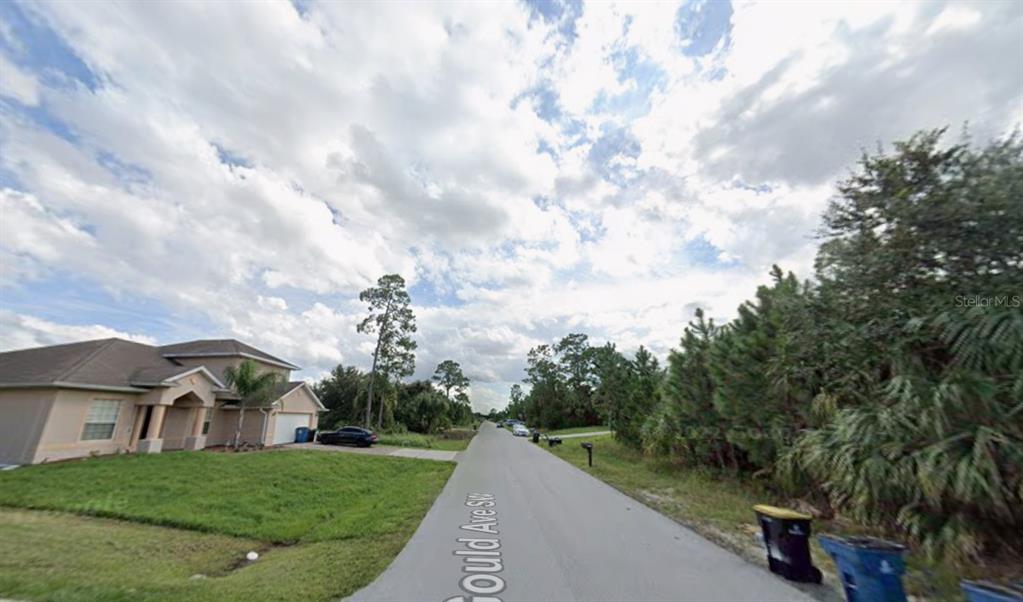 A suburban street view shows a single-family home on the left and wooded lots — 1756 GOULD AVENUE SW, PALM BAY, FL