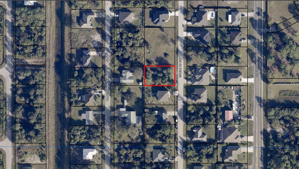 This is an aerial map view showing a vacant residential lot outlined in red — 1756 GOULD AVENUE SW, PALM BAY, FL