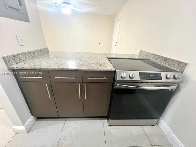 A kitchen features dark wood cabinets, a granite countertop, and a stainless steel electric range — 685 NE 85th St # 2, Miami FL 33138, MIAMI, FL