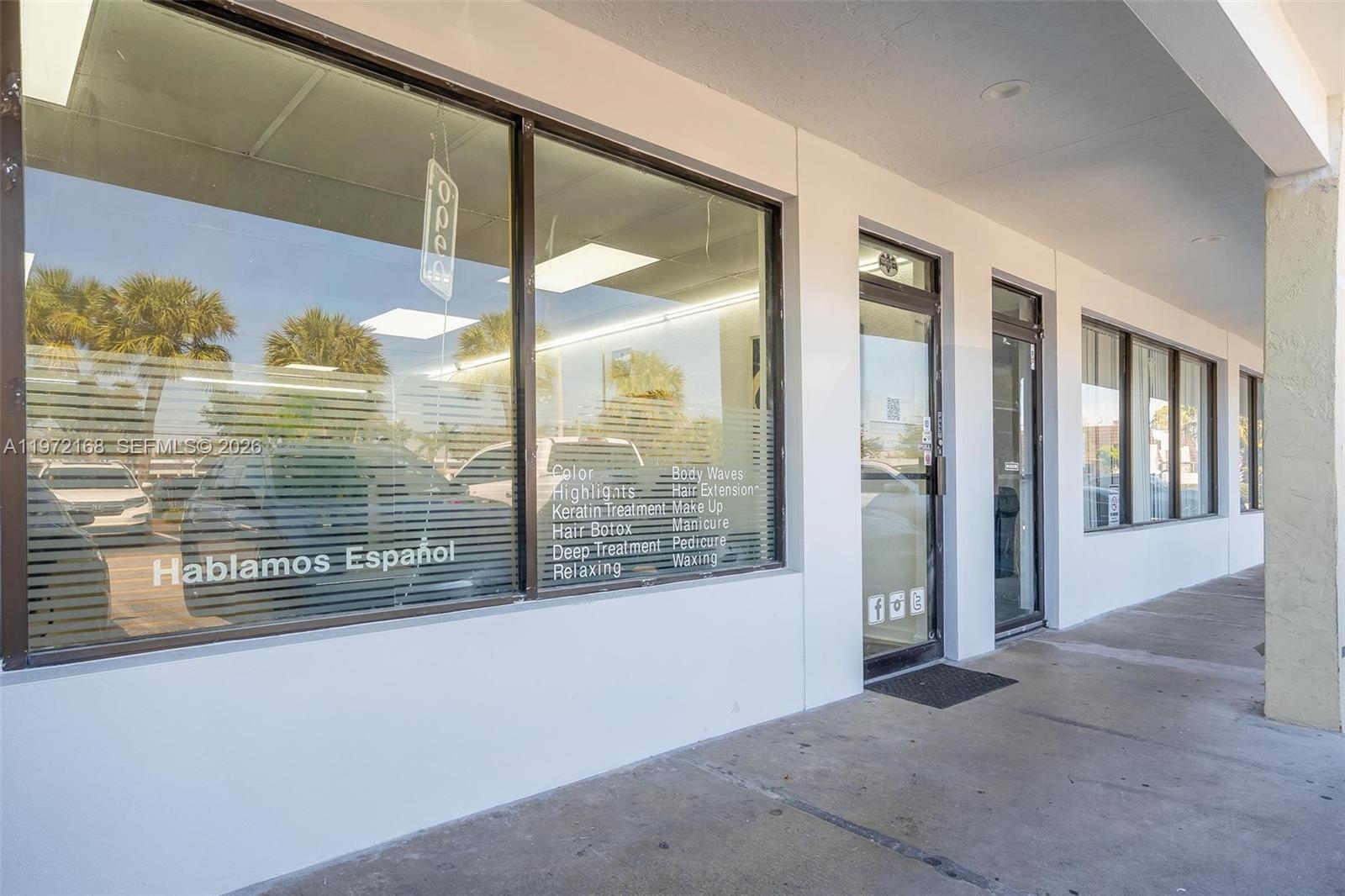The exterior of a commercial storefront features large glass windows displaying a list of services — Taft ST, Pembroke Pines FL 33024, PEMBROKE PINES, FL