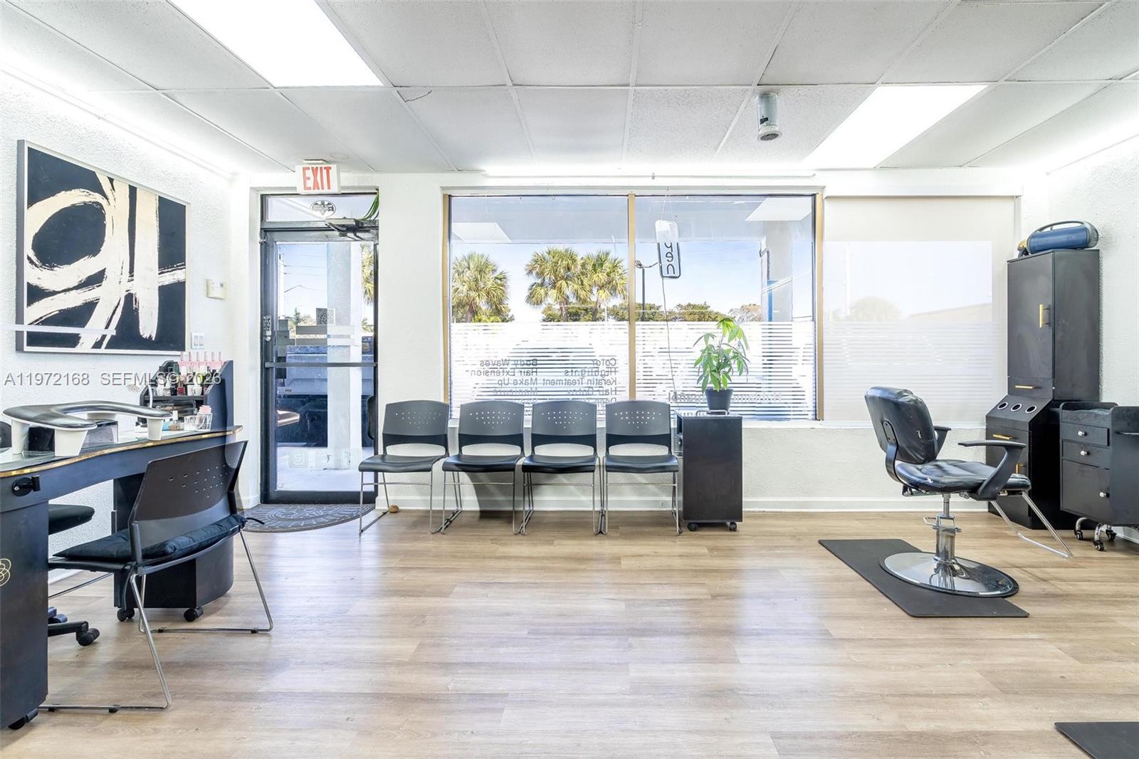 A salon interior features a waiting area with four chairs, a styling chair, and flooring — Taft ST, Pembroke Pines FL 33024, PEMBROKE PINES, FL
