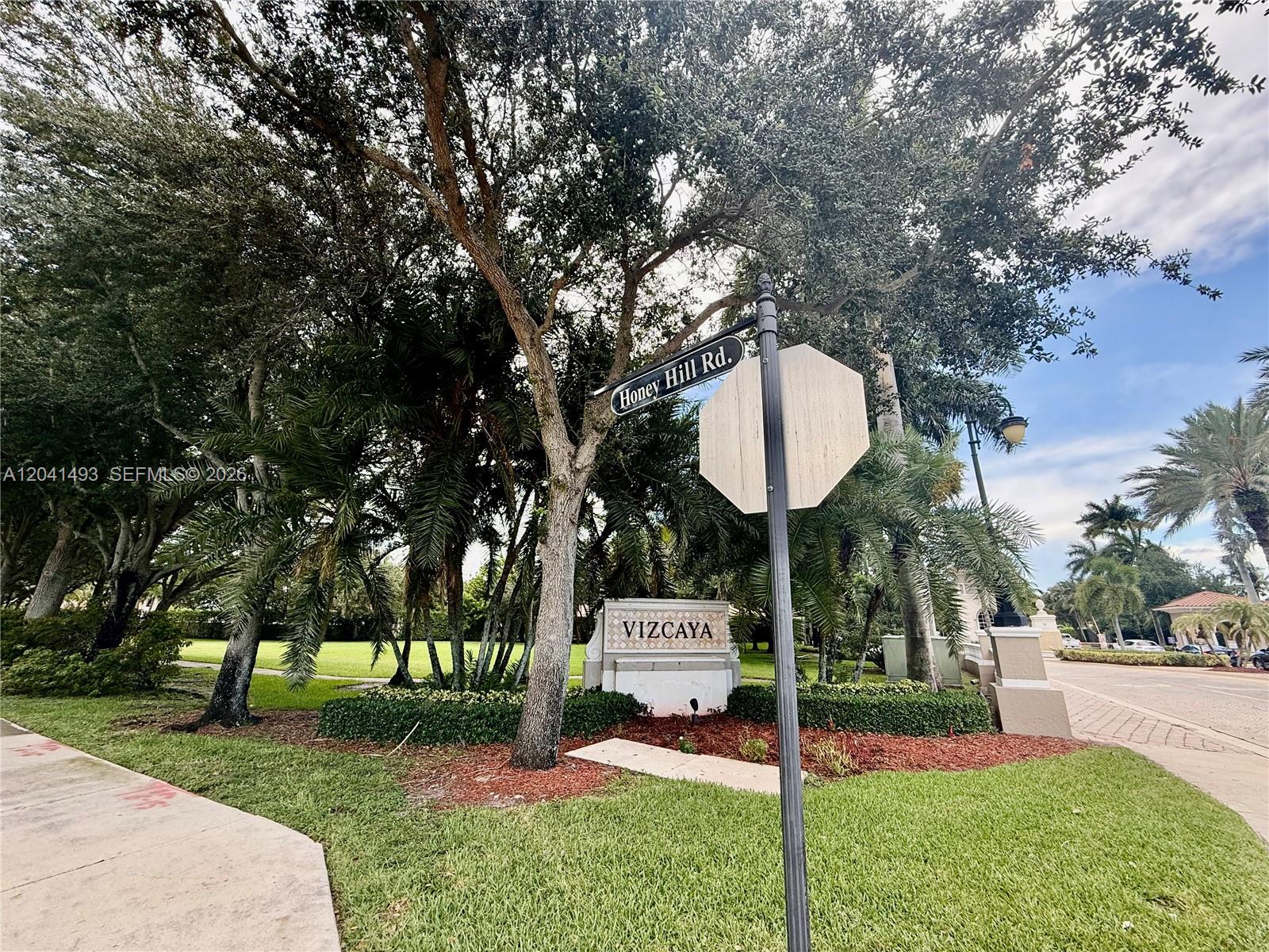 A street sign for Honey Hill Rd stands before a Vizcaya community entrance sign — 14051 SW 49th Ct # 7, Miramar FL 33027, MIRAMAR, FL
