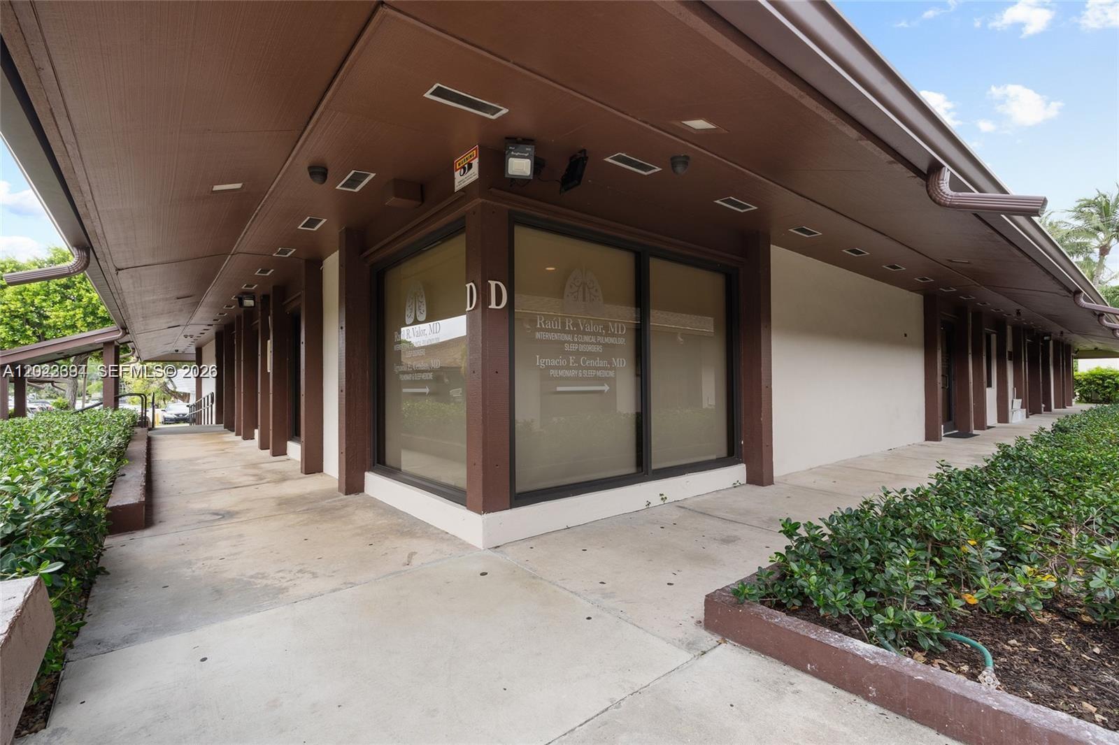 An exterior view of a commercial office building corner with signage for medical practices — 8525 SW 92nd St # 16, Miami FL 33156, MIAMI, FL