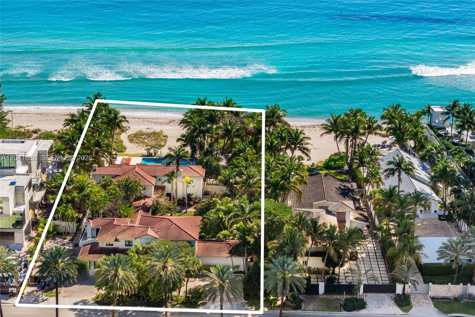 An aerial view shows a large beachfront estate with a pool and red-tiled roof — 115 Ocean Blvd, Golden Beach FL 33160, GOLDEN BEACH, FL