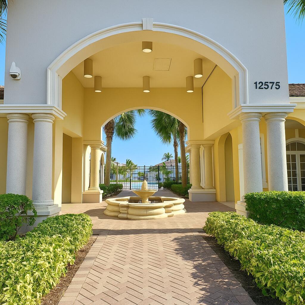 A stone fountain sits on a paved walkway beneath a large arched entryway with columns — 6777 Heritage # 1208, Boynton Beach FL 33437, BOYNTON BEACH, FL