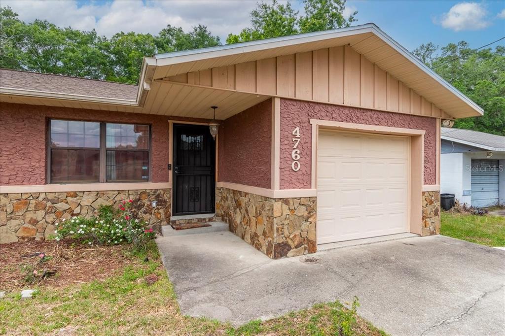 A living room features a lime green accent wall, tile flooring, and two sofas — 4760 NE 28TH TERRACE, OCALA, FL