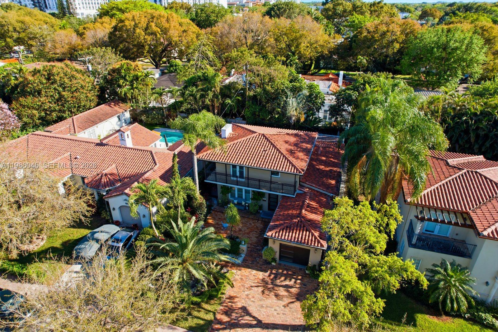 An aerial view shows a multi-story house with a red tile roof and brick driveway — 430 Candia Ave, Coral Gables FL 33134, CORAL GABLES, FL