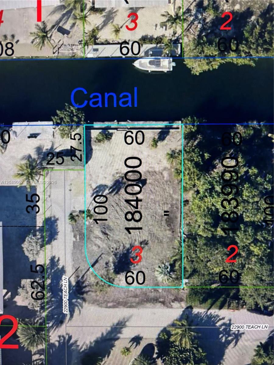 This is a satellite map view showing a vacant rectangular waterfront lot along a canal — LOWER KEYS, FL