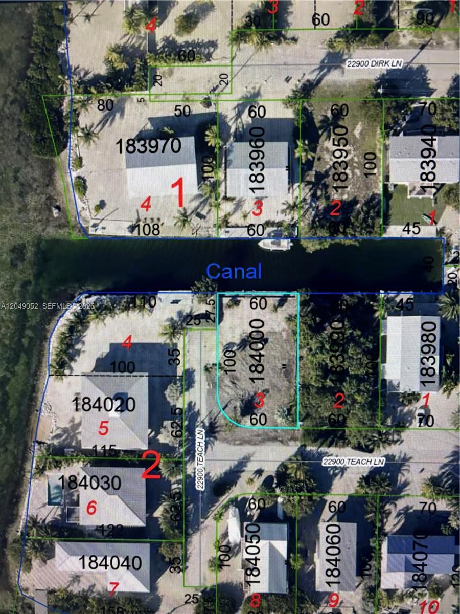 This is a satellite map showing residential property lots, a canal, and street names — LOWER KEYS, FL