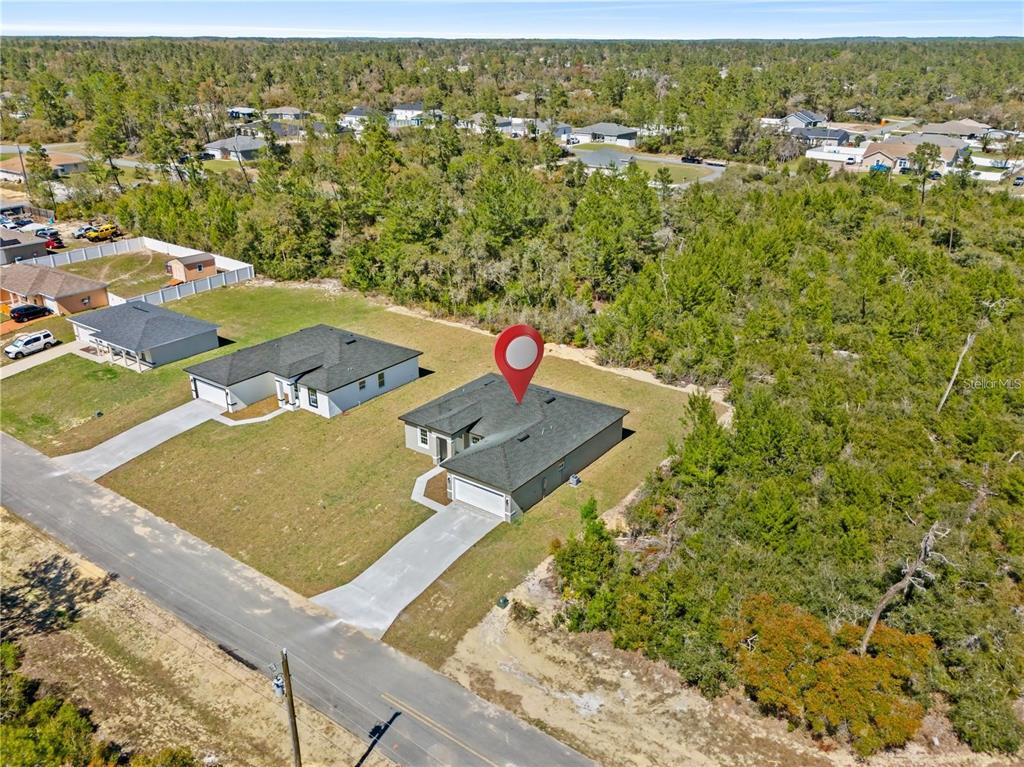 An aerial view shows a single-story house with a gray roof and a concrete driveway — 16753 SW 29TH TERRACE, OCALA, FL
