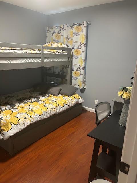 A bedroom features a wooden bunk bed with yellow floral bedding and a black desk — 815 W BOYNTON BEACH Boulevard # 202, Boynton Beach FL 33426, BOYNTON BEACH, FL
