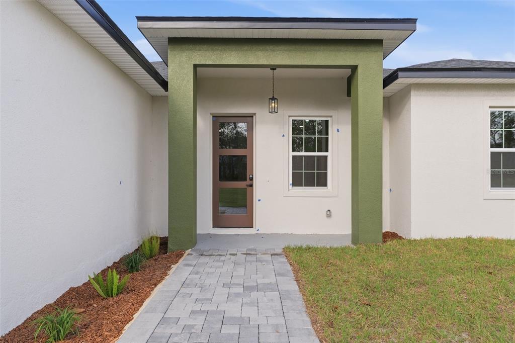 A room with light wood flooring, white walls, a closet, a window, and a glass door — 15088 SW 51ST AVENUE, OCALA, FL