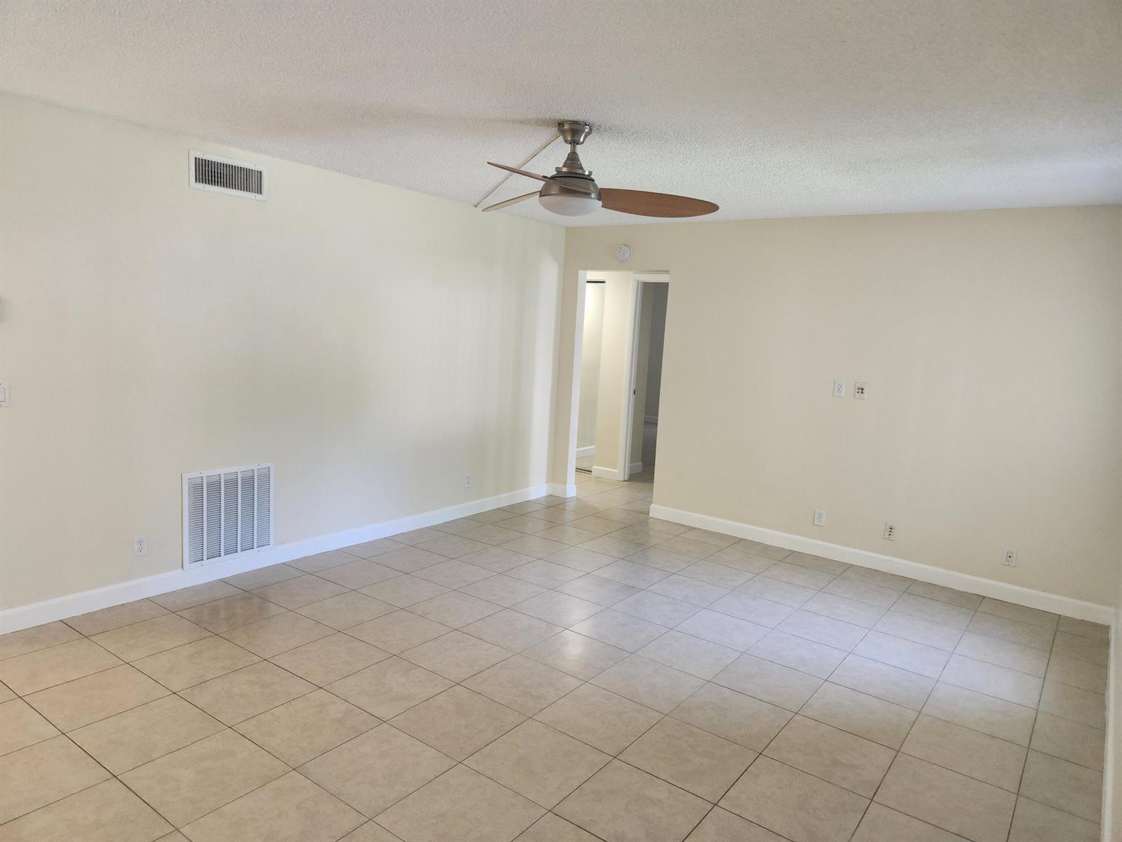 An empty room with beige tile flooring, a ceiling fan, and light-colored walls — 4731 Sable Pine Circle # B1, West Palm Beach FL 33417, WEST PALM BEACH, FL