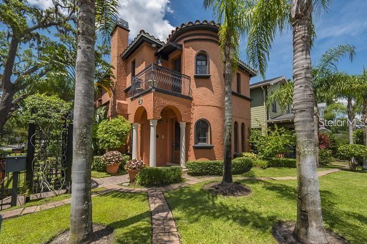A two-story stucco house with a rounded turret, arched entryway, and a second-floor balcony — 503 N SUMMERLIN AVENUE, ORLANDO, FL
