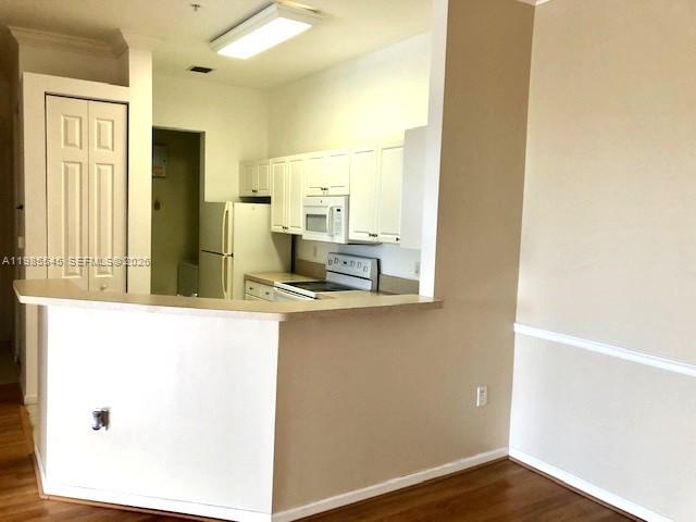 A kitchen with white cabinets, a breakfast bar, and light-colored walls — 4702 SW 160th Ave # 337, Miramar FL 33027, MIRAMAR, FL