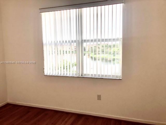A room with wood-look flooring, white walls, and a window with vertical blinds — 4702 SW 160th Ave # 337, Miramar FL 33027, MIRAMAR, FL