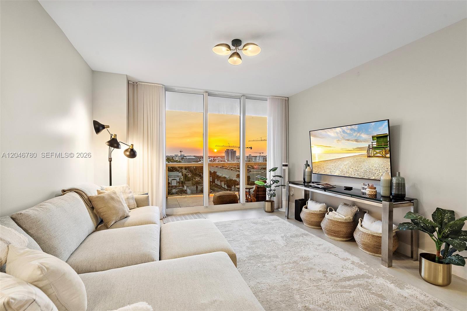 A living room features a sectional sofa, a television on a console, and balcony views — 9595 Collins Ave, Surfside FL 33154, SURFSIDE, FL