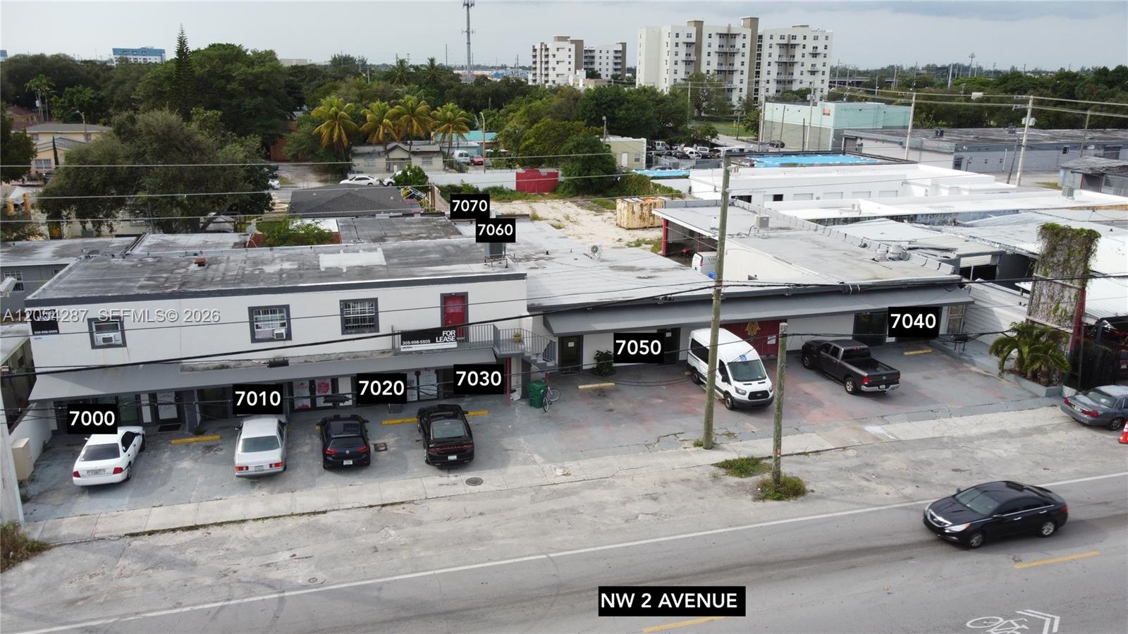 An aerial view shows a commercial building complex with multiple storefronts and a parking lot — 7000 NW 2 Ave # 7000, Miami FL 33150, MIAMI, FL