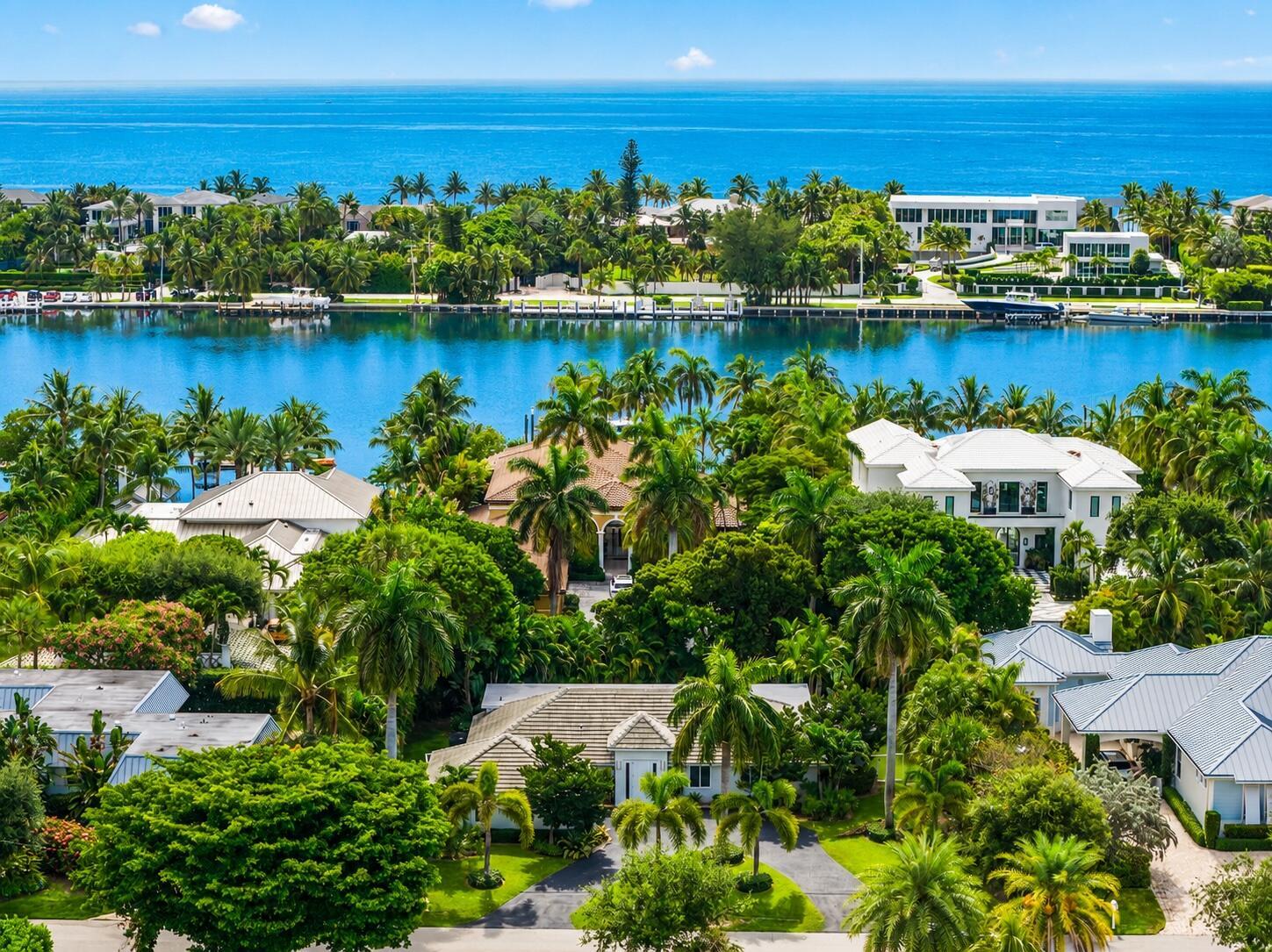 An aerial view of waterfront luxury homes surrounded by lush tropical landscaping and palm trees — 1386 S Atlantic Drive, Lantana FL 33462, LANTANA, FL