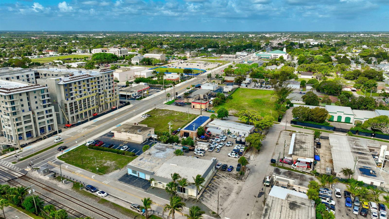 An aerial view shows a multi-story building under construction next to a street and railroad — 321 N Railroad Avenue, Boynton Beach FL 33435, BOYNTON BEACH, FL