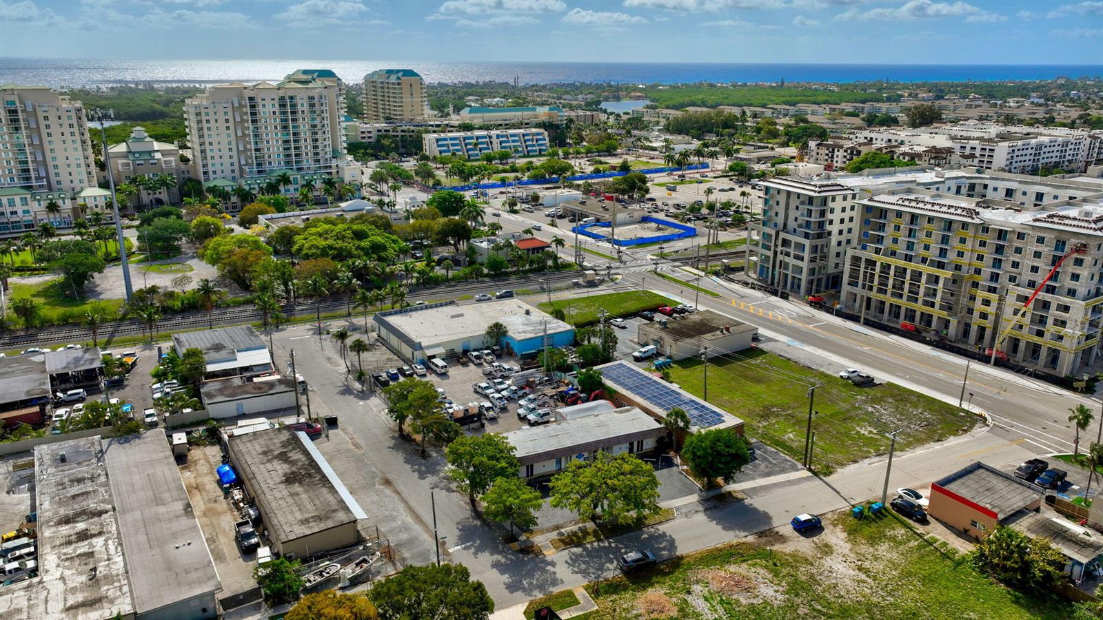 An aerial view shows a mix of commercial buildings, construction sites, and residential high-rises — 321 N Railroad Avenue, Boynton Beach FL 33435, BOYNTON BEACH, FL
